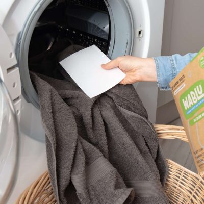 Wablu Laundry sheet in hand going into washing machine
