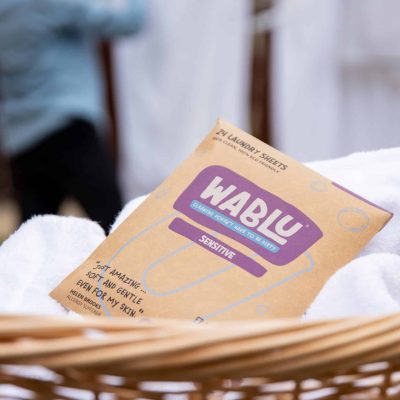 wablu sensitive pack in front of lady hanging out laundry