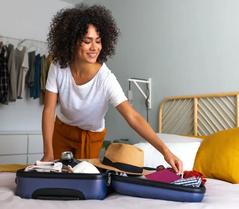 African American young woman packing the best laundry sheets for travel